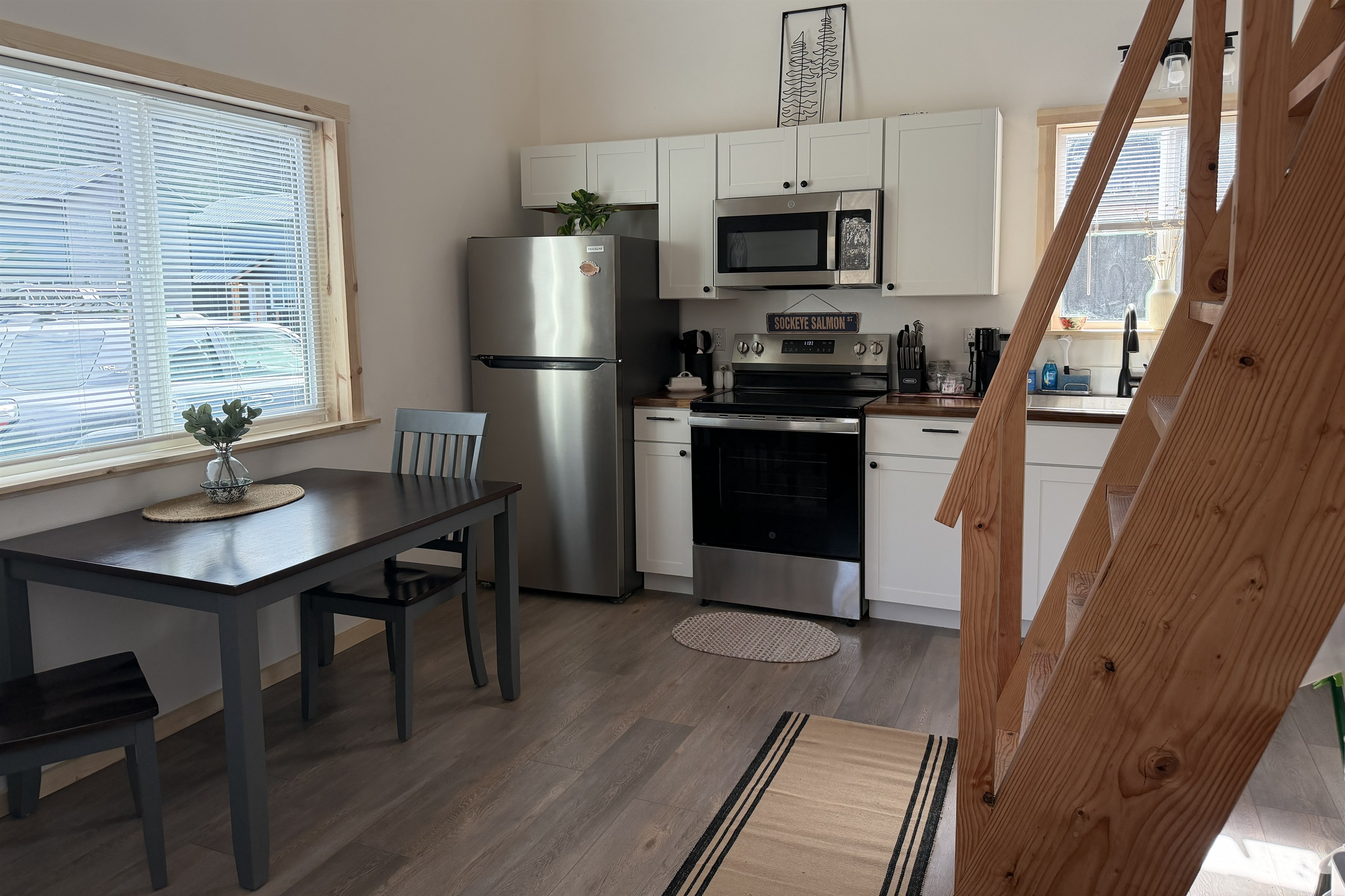 Main floor dining and kitchen area and ships ladder accessing loft