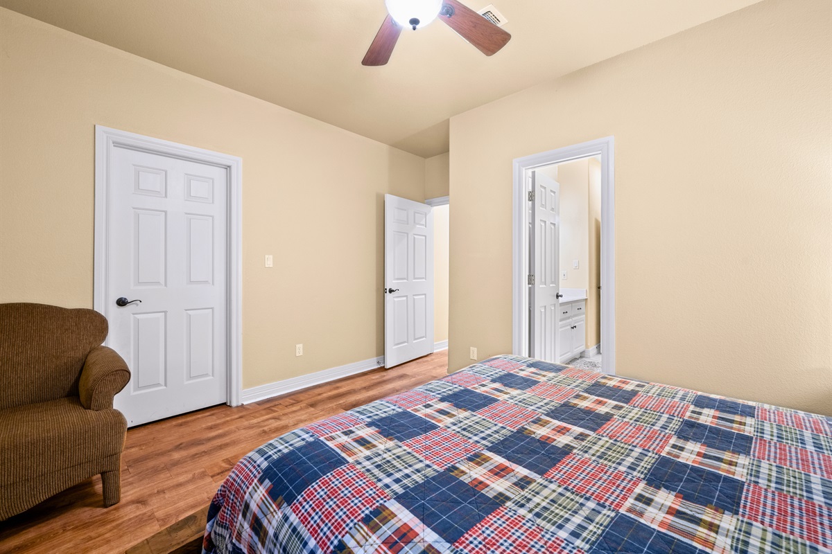 Spacious queen bedroom with attached bath access.