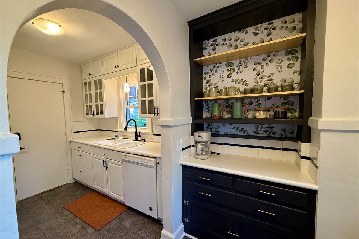 Archways from the Breakfast Nook to the fully stocked kitchen.
