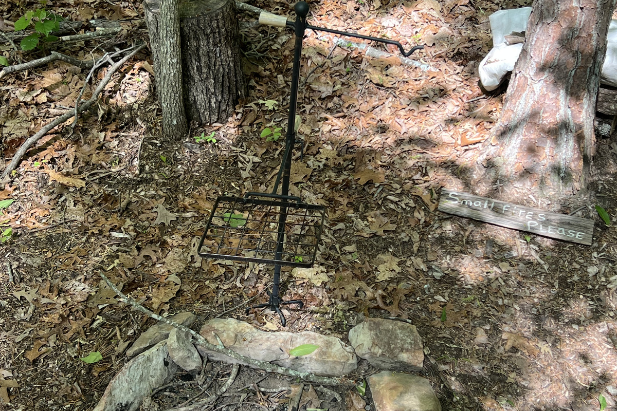 Cook over the fire with the included cooking grate and pot hanger