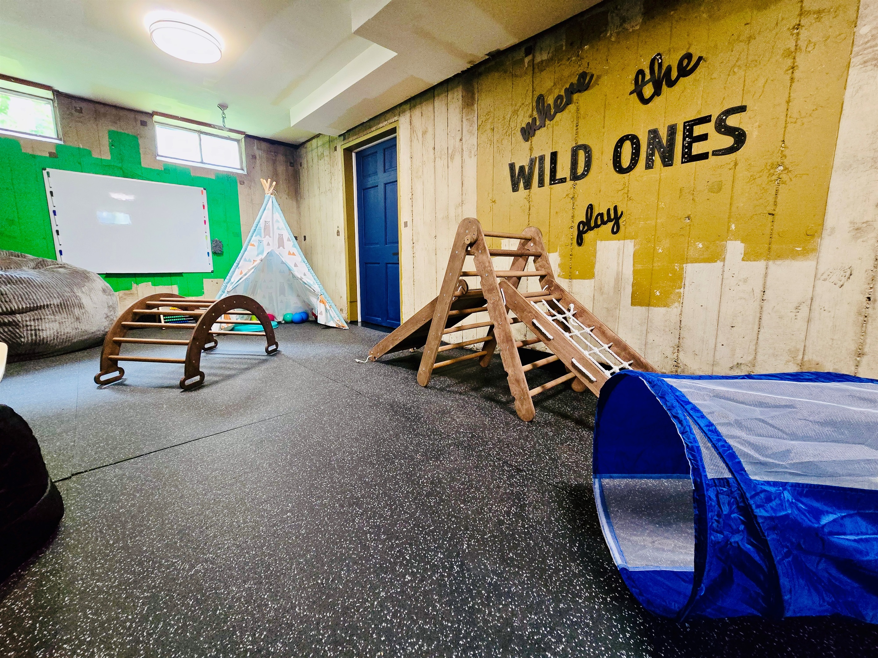 A space built for imagination—ND hues, industrial charm, and a cozy corner where the wild ones can play, dream, and be themselves.