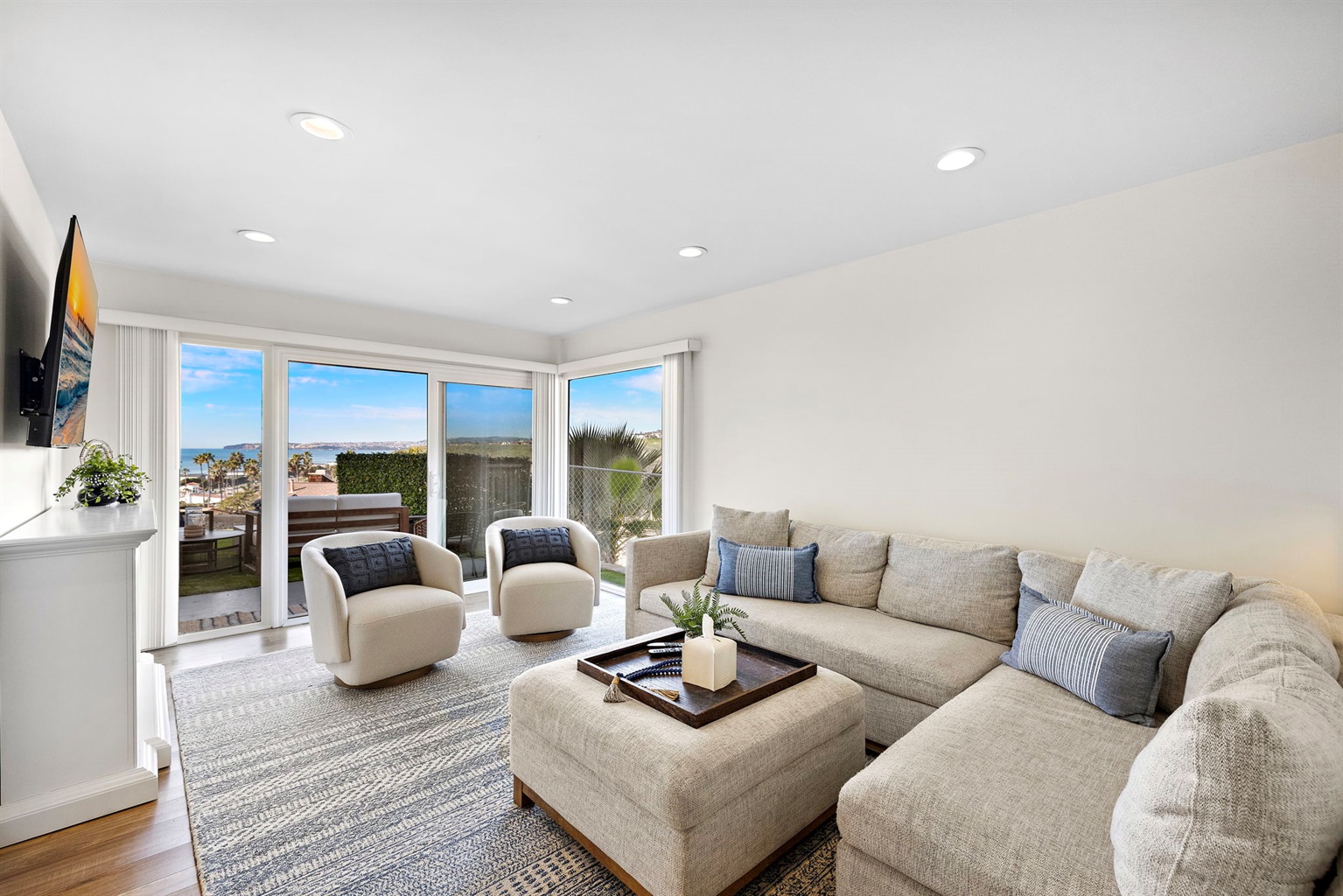 New listing from hosts with 4.99 star rating.  The living room has lots of comfortable seating, views and natural light pouring in from the back yard.