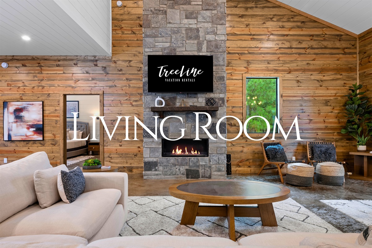 Living room with stone fireplace and flat-screen TV for relaxing nights.