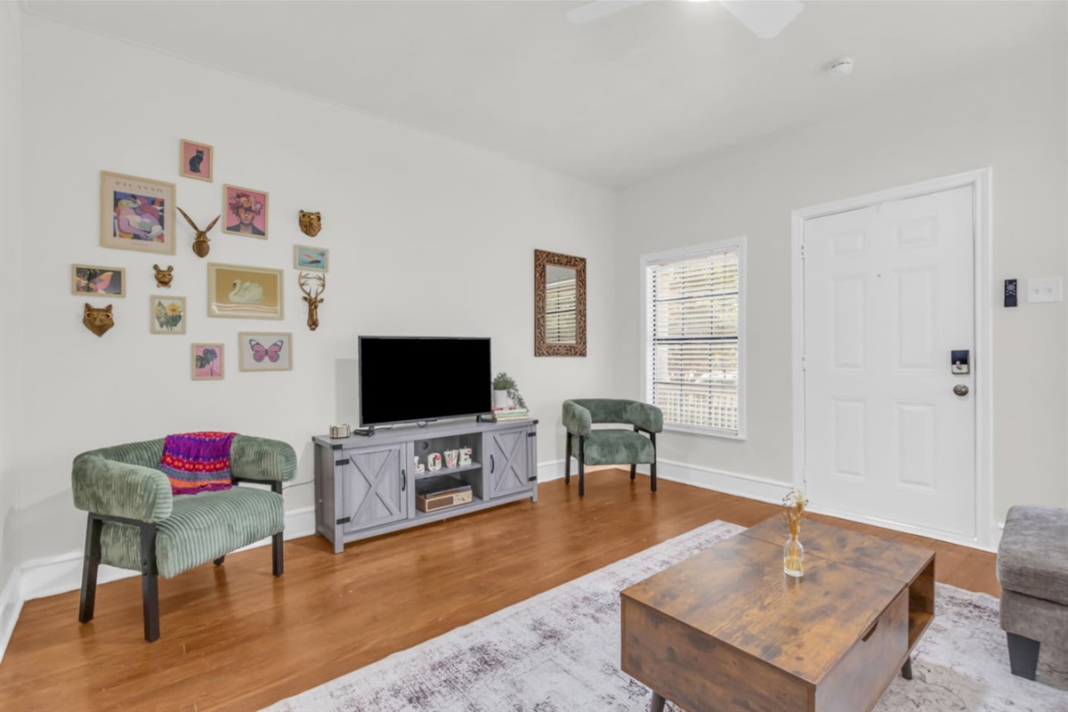 Living area with sectional sofa, TV with Roku, and open layout.