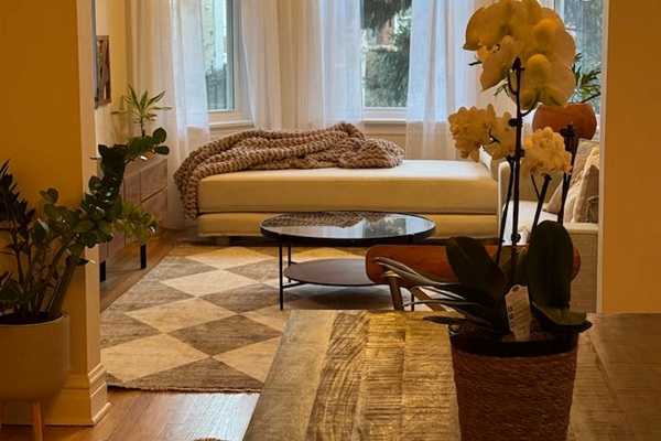 Bright living room with cozy seating and large windows bringing in natural light.