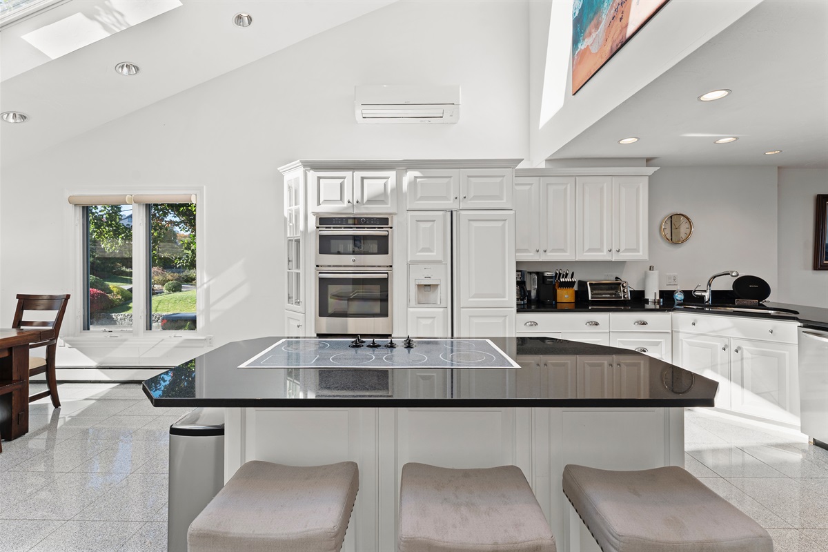 Modern kitchen with island and complete amenities for your convenience.