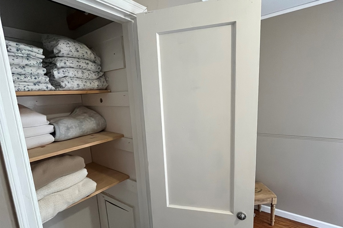 A closet full of additional bedding for the guests' comfort.