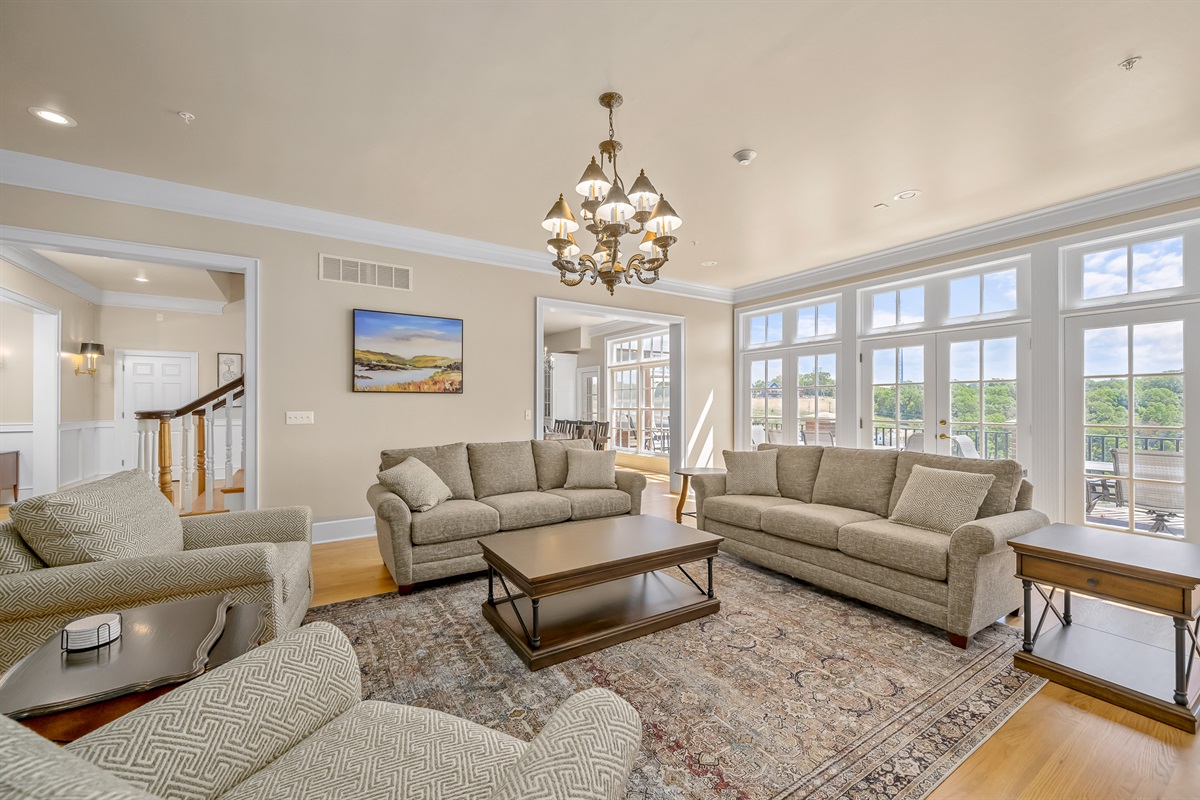 Views off of the living room overlooking the lake. Sofa table near french doors serves as additional dining seating.