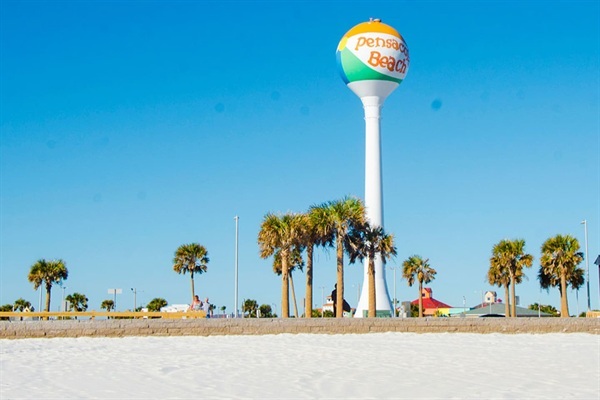 The iconic Pensacola Beach water tower welcomes visitors to one of the Gulf Coast’s most beautiful destinations. Surrounded by palm trees and bright white sand, it’s a popular landmark and the perfect starting point for a day of sun, surf, and coastal fun.