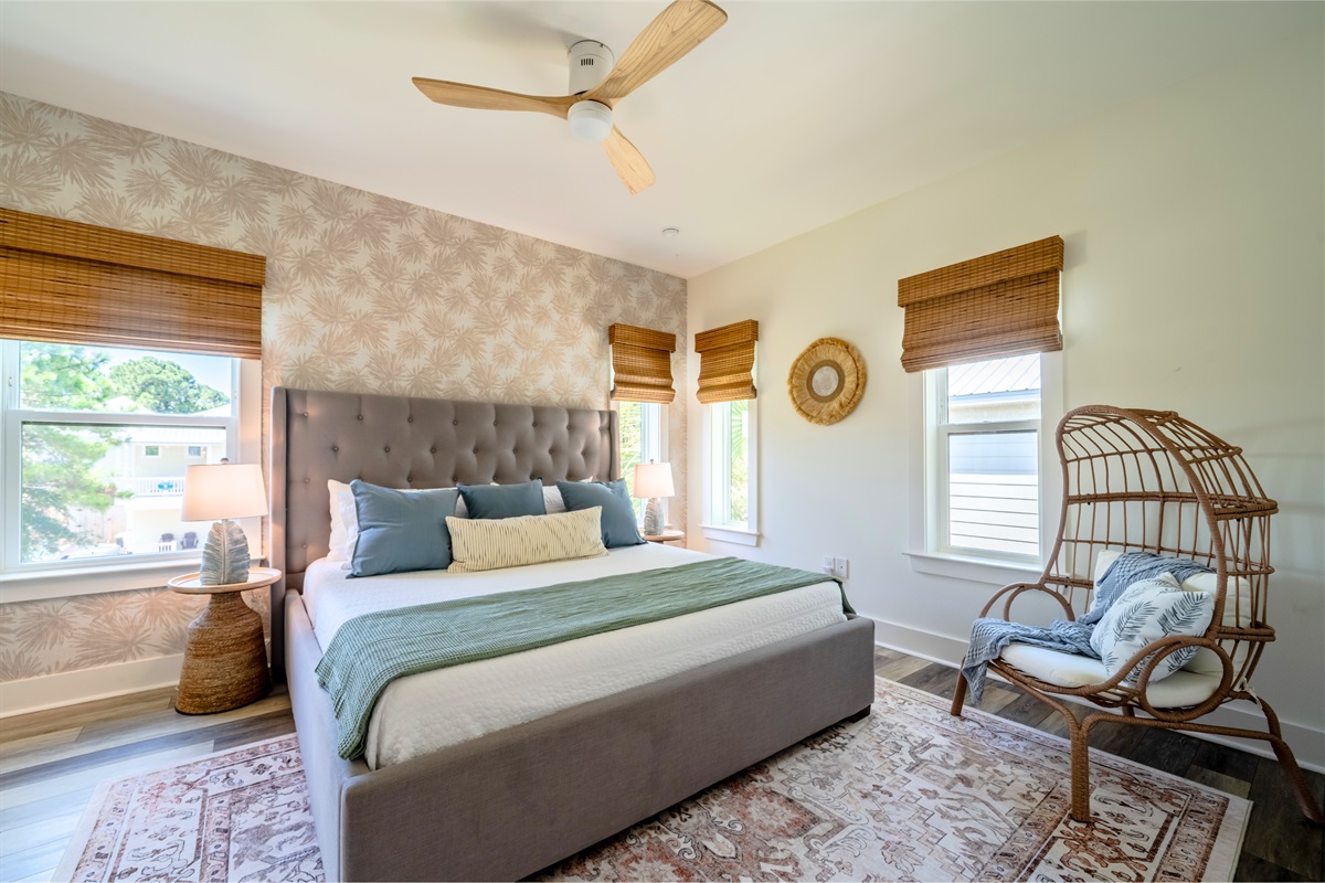 Serene primary bedroom with a king bed, stylish decor, and natural light - your cozy retreat awaits!