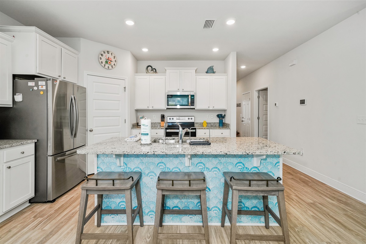 Fully stocked main kitchen with 3 bar stools