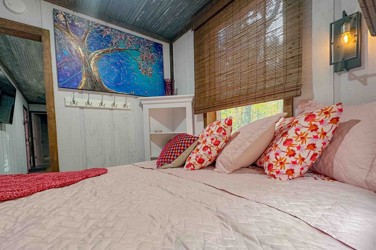 Original artwork, bamboo window shades on all three bedroom windows, and 100% cotton bed linens give this bedroom a cozy, comfortable feel. 