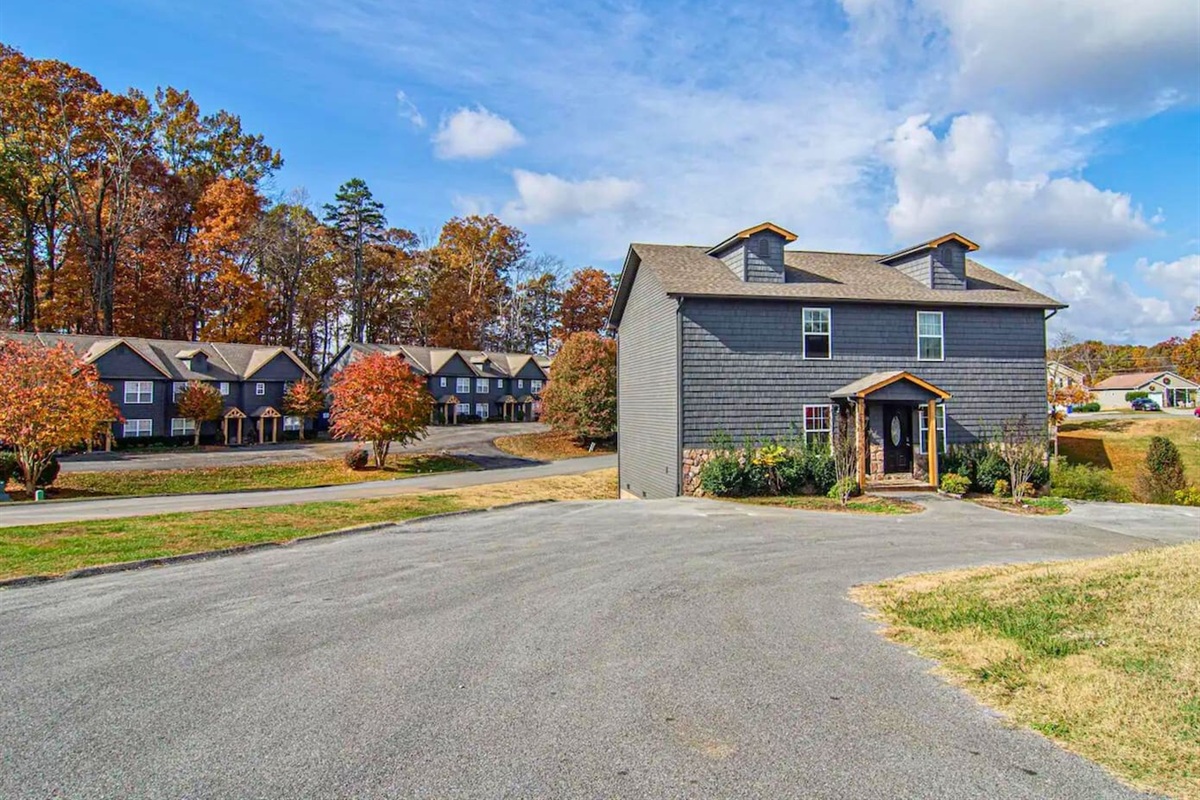 Your vacation home sits cozily amongst the vibrant trees, inviting you into a world of warmth and comfort.