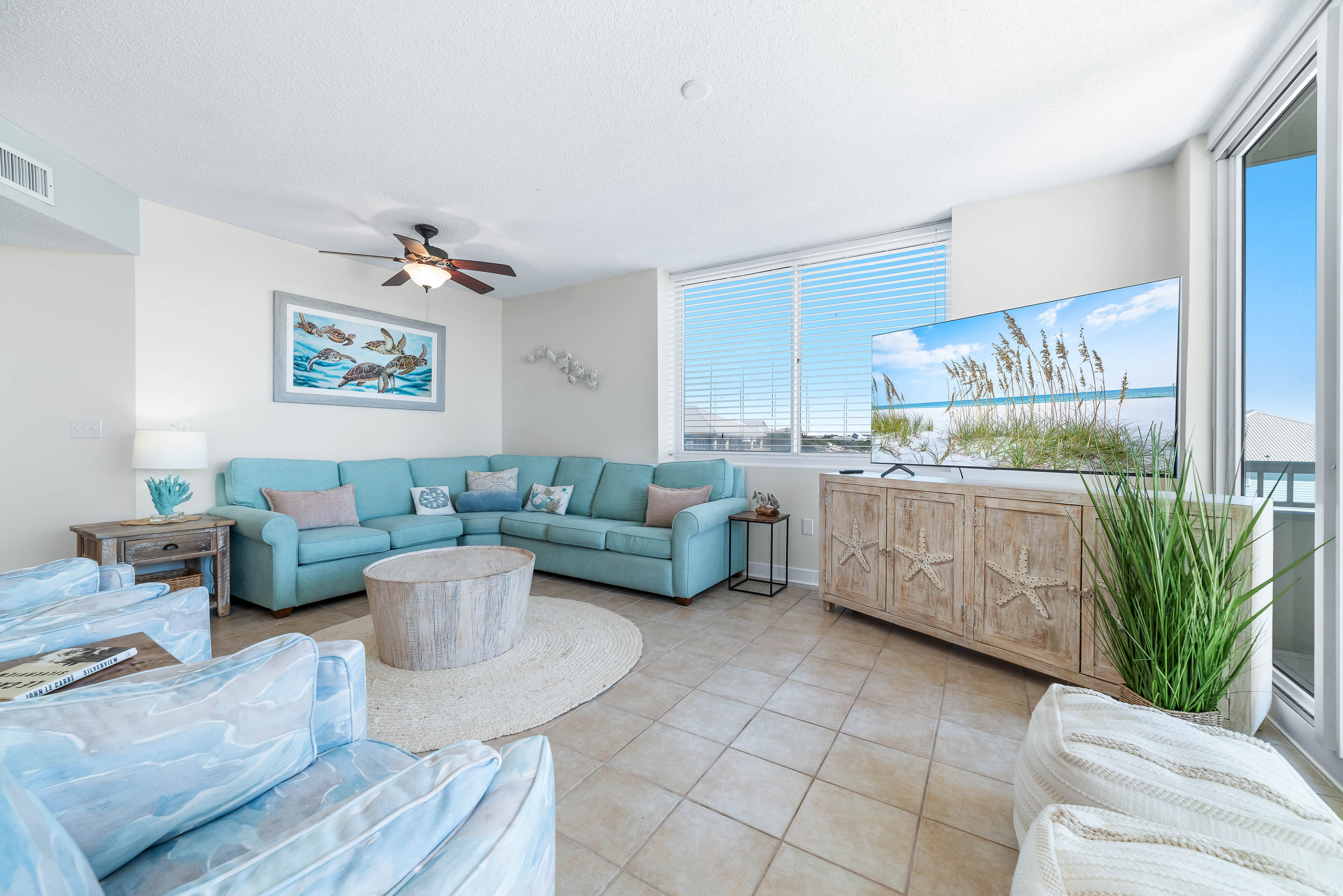 This beautifully appointed living area offers comfortable seating, a large screen TV, and direct access to a private balcony with breathtaking views.