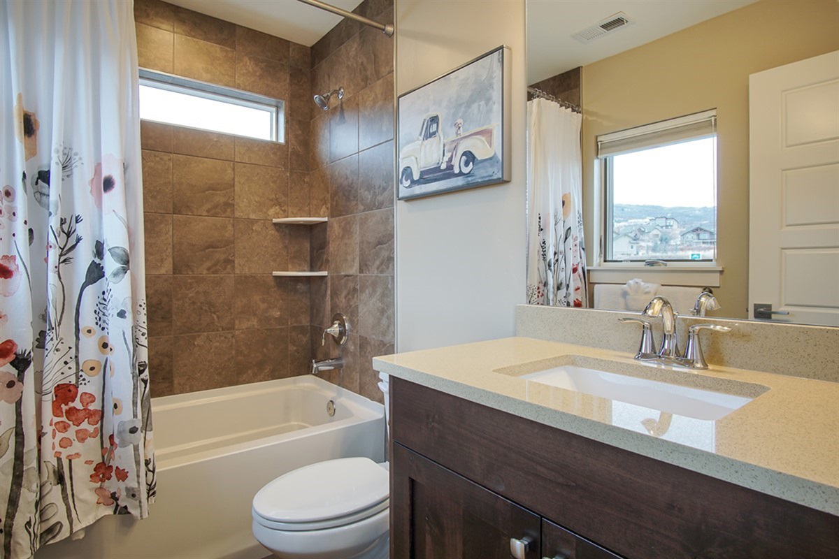 Additional full bathroom with clean design and plenty of space.