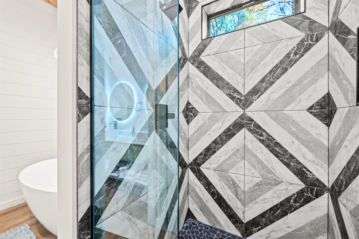 The beautifully tiled shower adds a touch of modern elegance, creating a spa-like space to refresh and unwind after a long day of adventure.