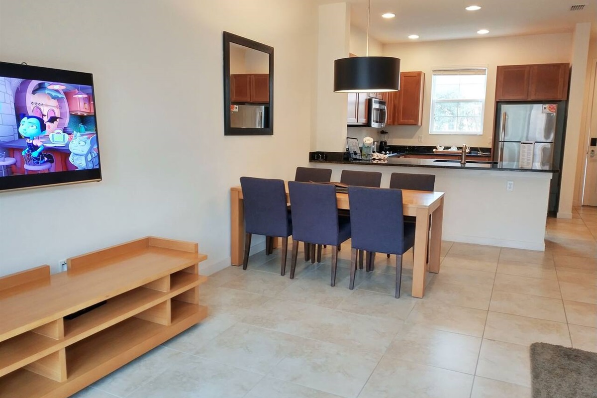 Back inside, is the bright living room area with a Smart TV with cable.