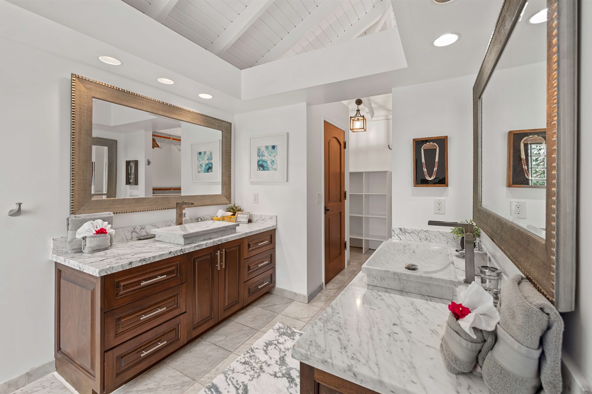 The ensuite bathroom to the primary with double vanities, large closet and walk in marble shower.
