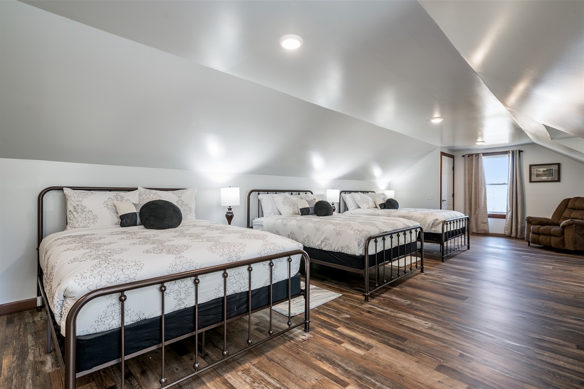 Perfect for families or groups, this bright bedroom offers multiple beds and plenty of space to spread out.