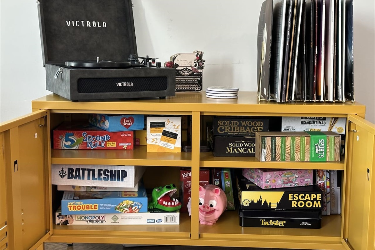 Games conveniently located in TV stand, as well as Victrola and Records to Enjoy!