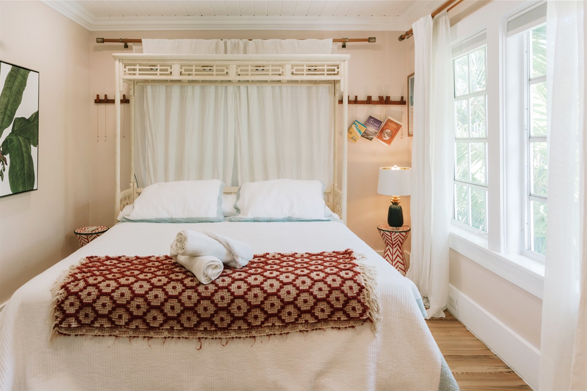 The main bedroom is comfortably furnished, with a pleasant view overlooking the pool.