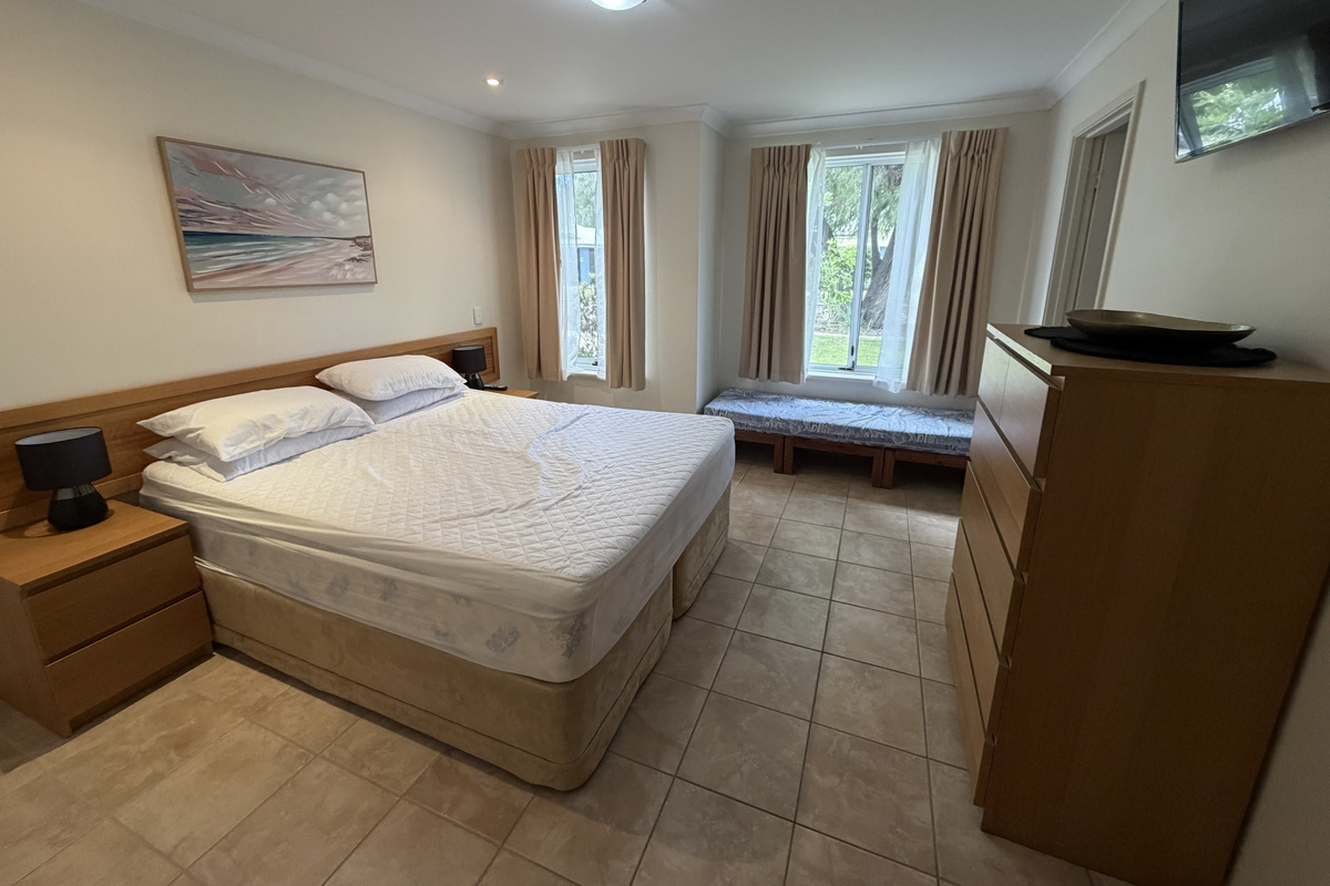 Main Bedroom with Queen Bed, Childs sofa bed & TV on wall