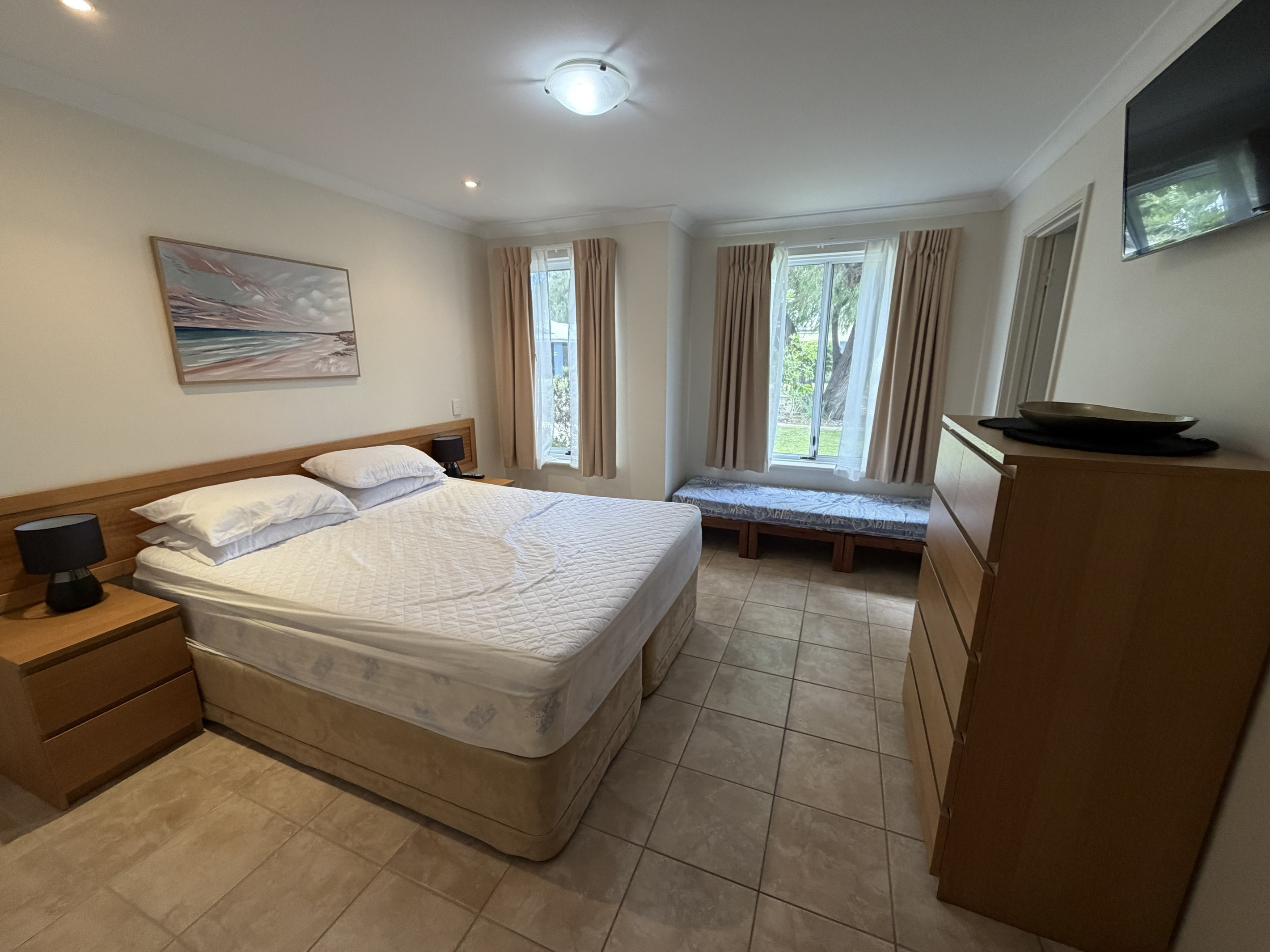 Main Bedroom with Queen Bed, Childs sofa bed & TV on wall