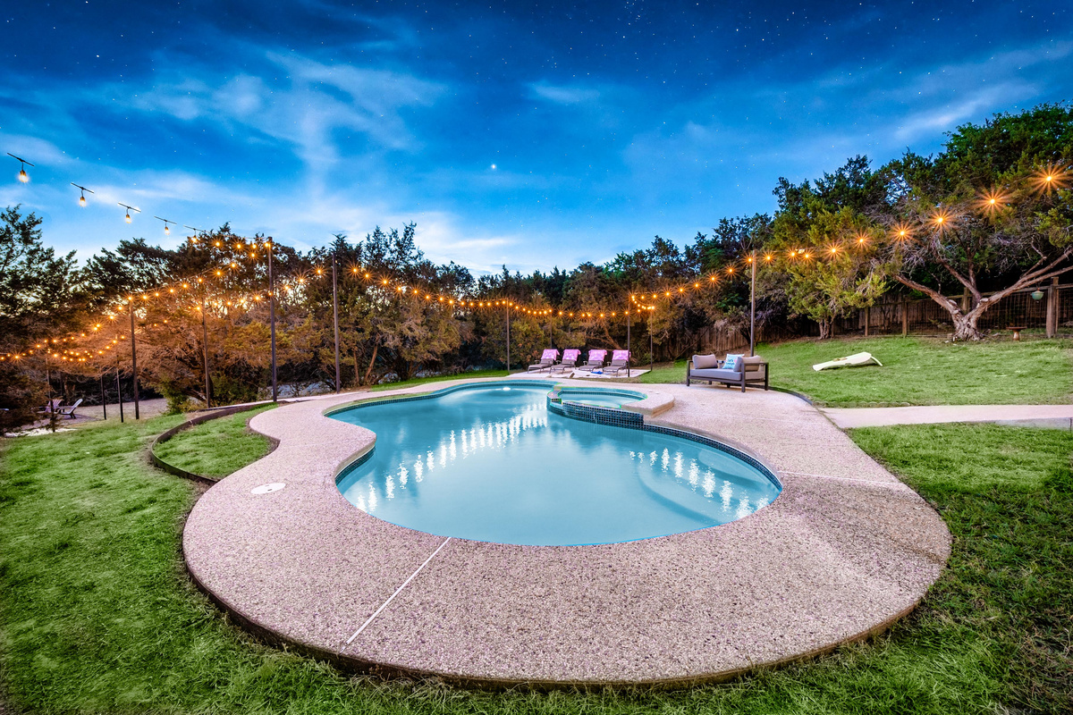 Twilight views of the pool, framed by lush landscaping
