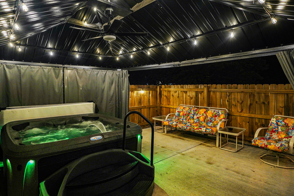 Hot tub patio enclosed by a privacy fence...curtains can be closed for COMPLETE hot tub privacy. 