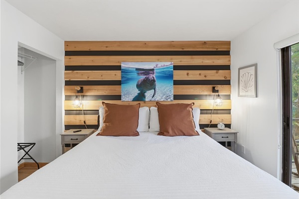 Downstairs bedroom with king bed, Roku TV and view of the canal and backyard