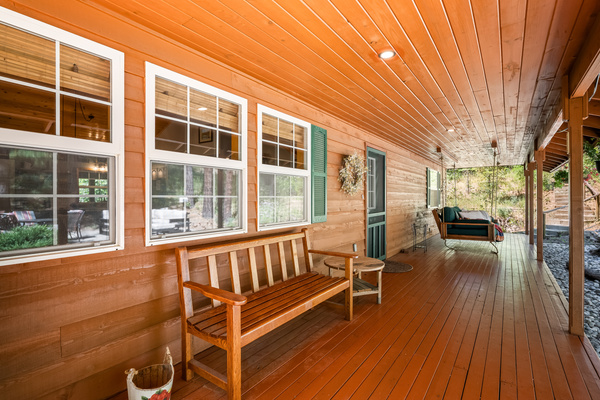 Front porch with bench and hanging day bed