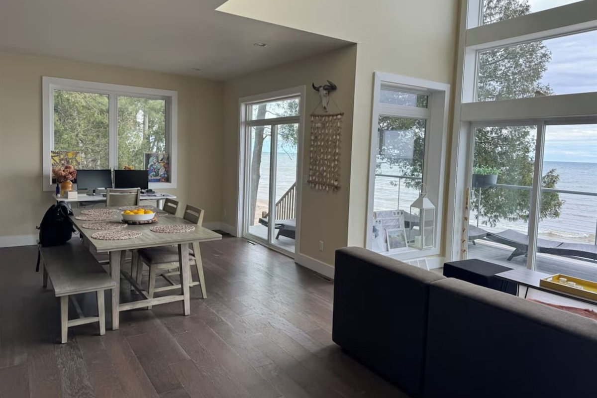 Dining nook by large windows, perfect for meals w/ a bright, airy feel