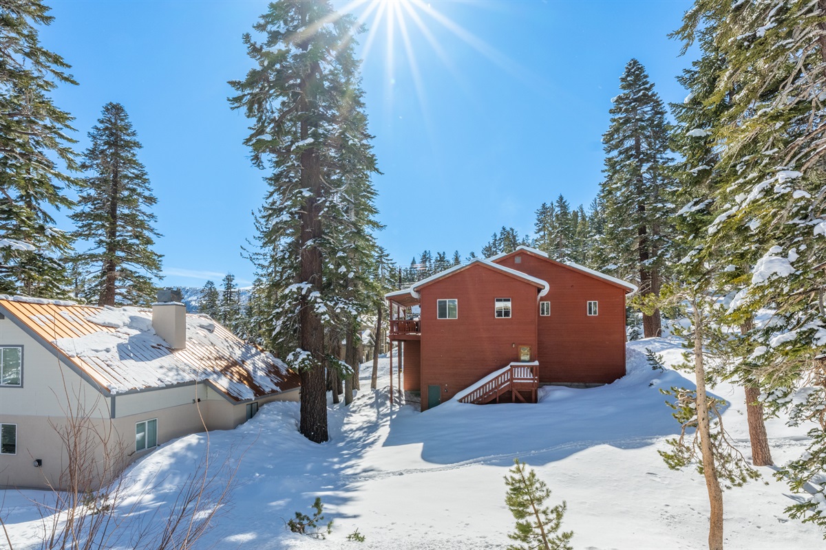 A shared back garden offers open space to relax, play, and take in the mountain setting—quiet, green in summer, and snow-covered in winter.