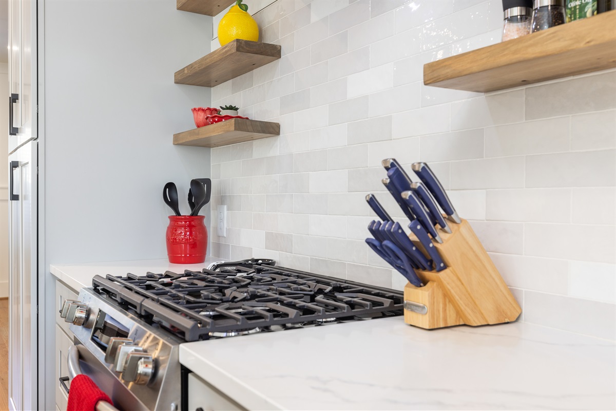 The gas range is perfect for cooking meals at home with friends and family. The kitchen is fully stocked.