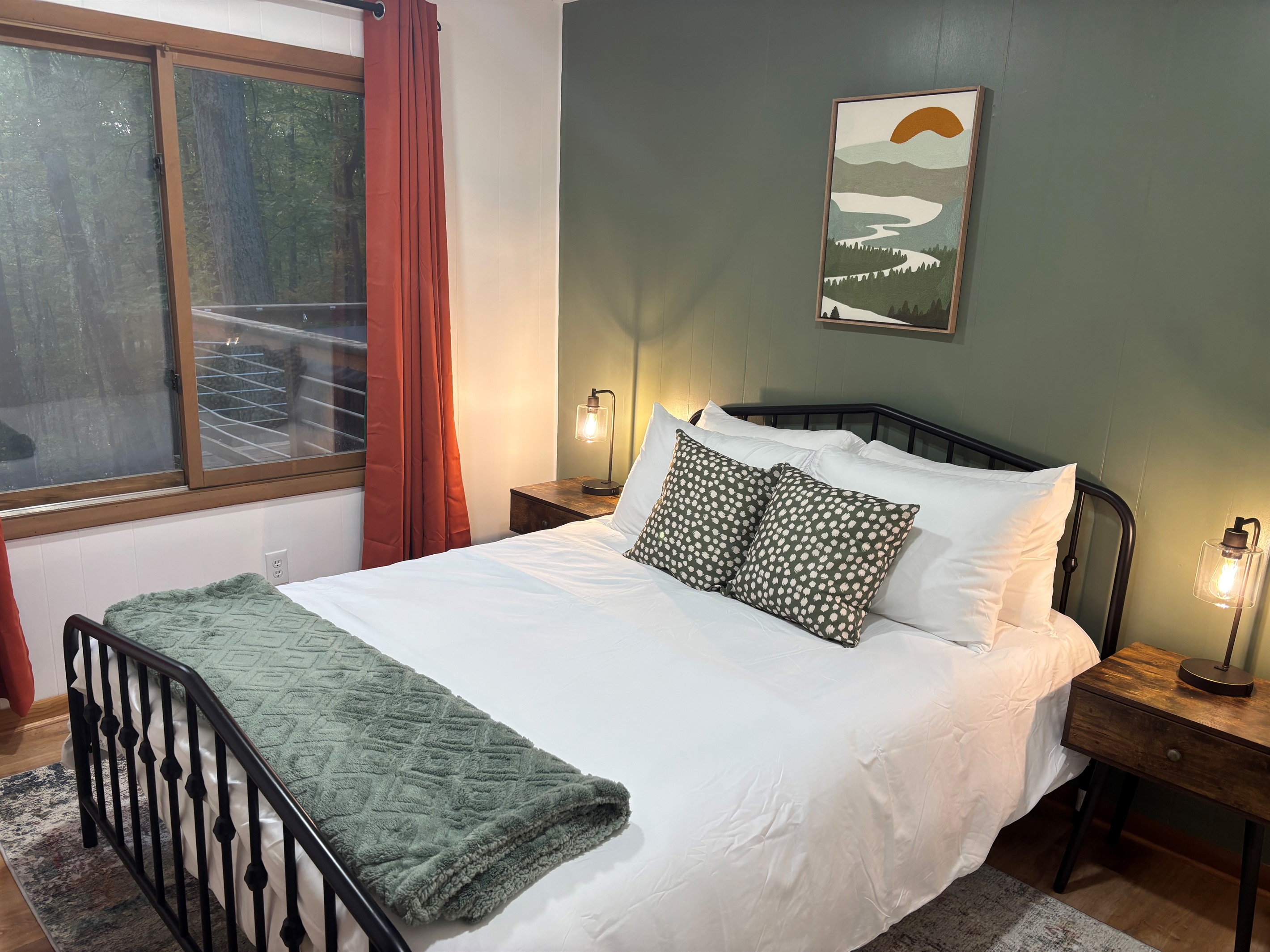 Enjoy restful nights in this Queen bedroom with calming views of the surrounding forest.