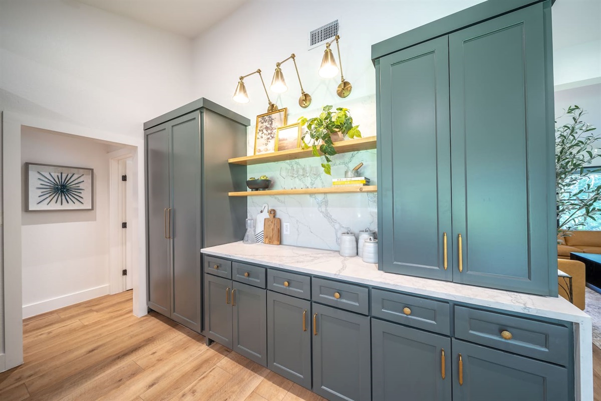 Alternate angle of the kitchen showing ample prep space, custom cabinetry, and thoughtful layout for cooking and entertaining. This kitchen comes with all you need to cook an amazing meal, even if you aren't a professional chef.