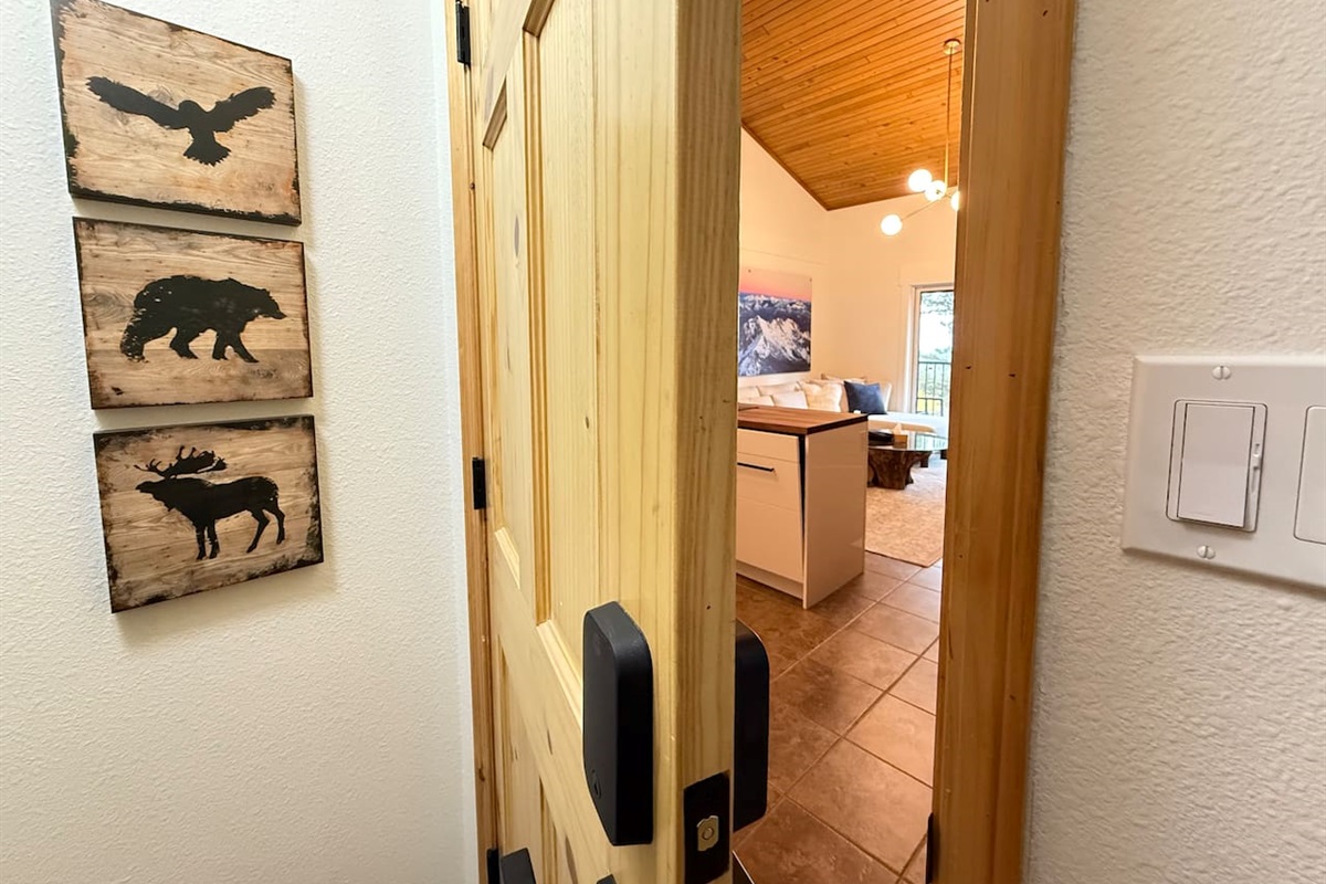 Mountain Theme Welcome: The entryway features charming local wildlife art and provides easy access to the main living areas of the mountain retreat property.
