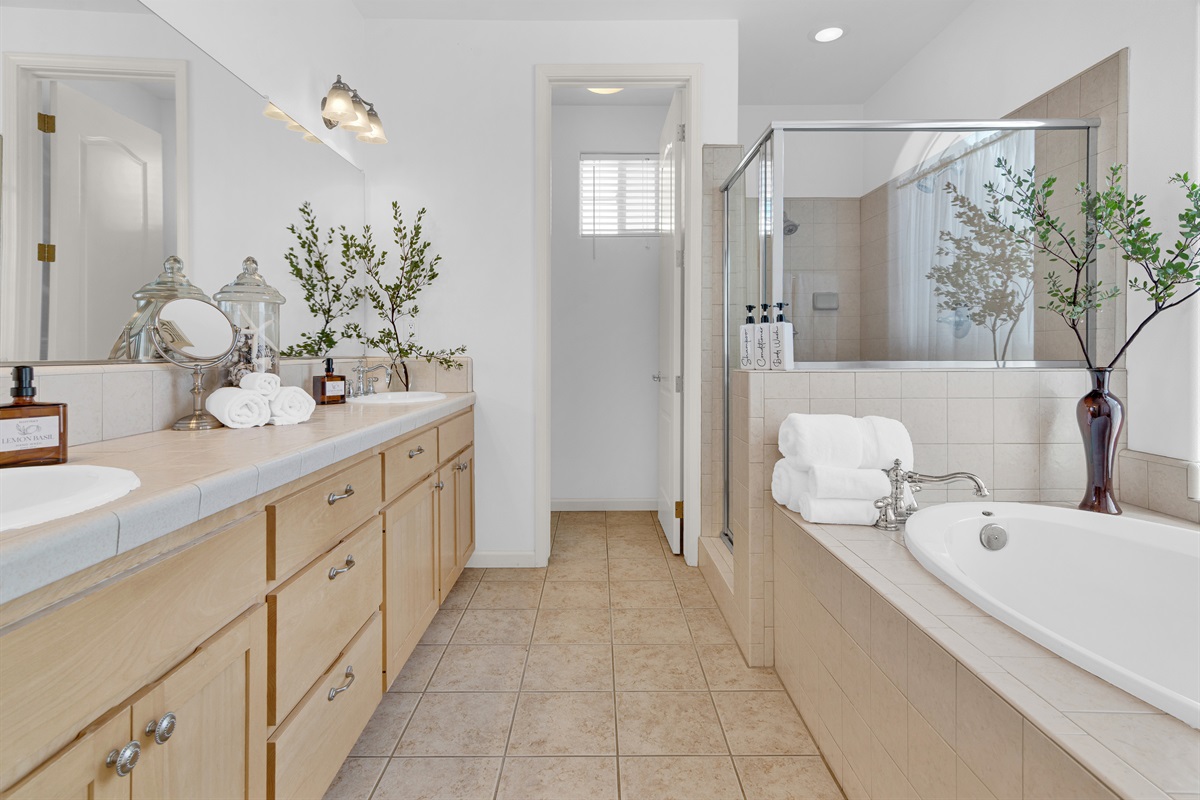 Primary ensuite bathroom creates a spa-like experience. Double sinks, plenty of counter space, soaking tub and separate shower make for a pleasant experience. 