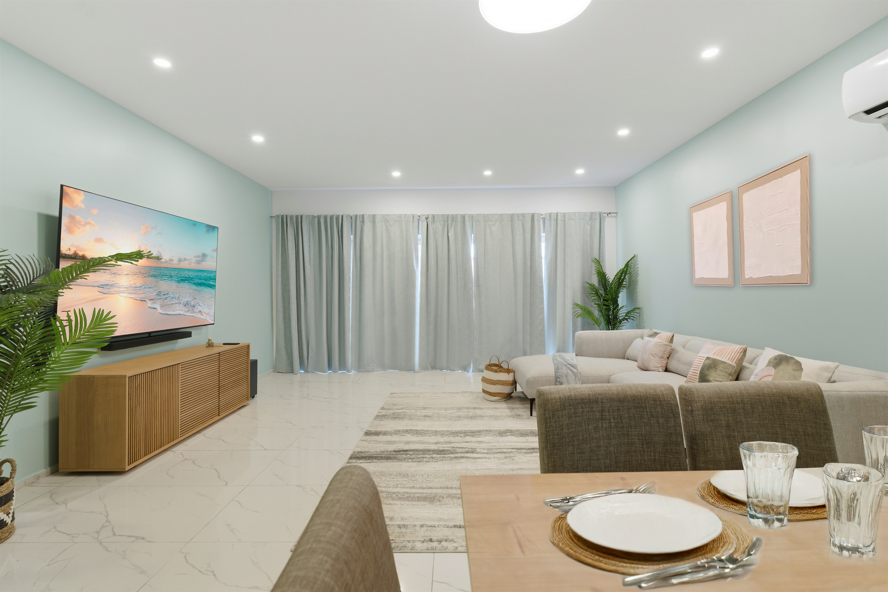 Large windows bring in natural light while full curtains provide privacy anytime