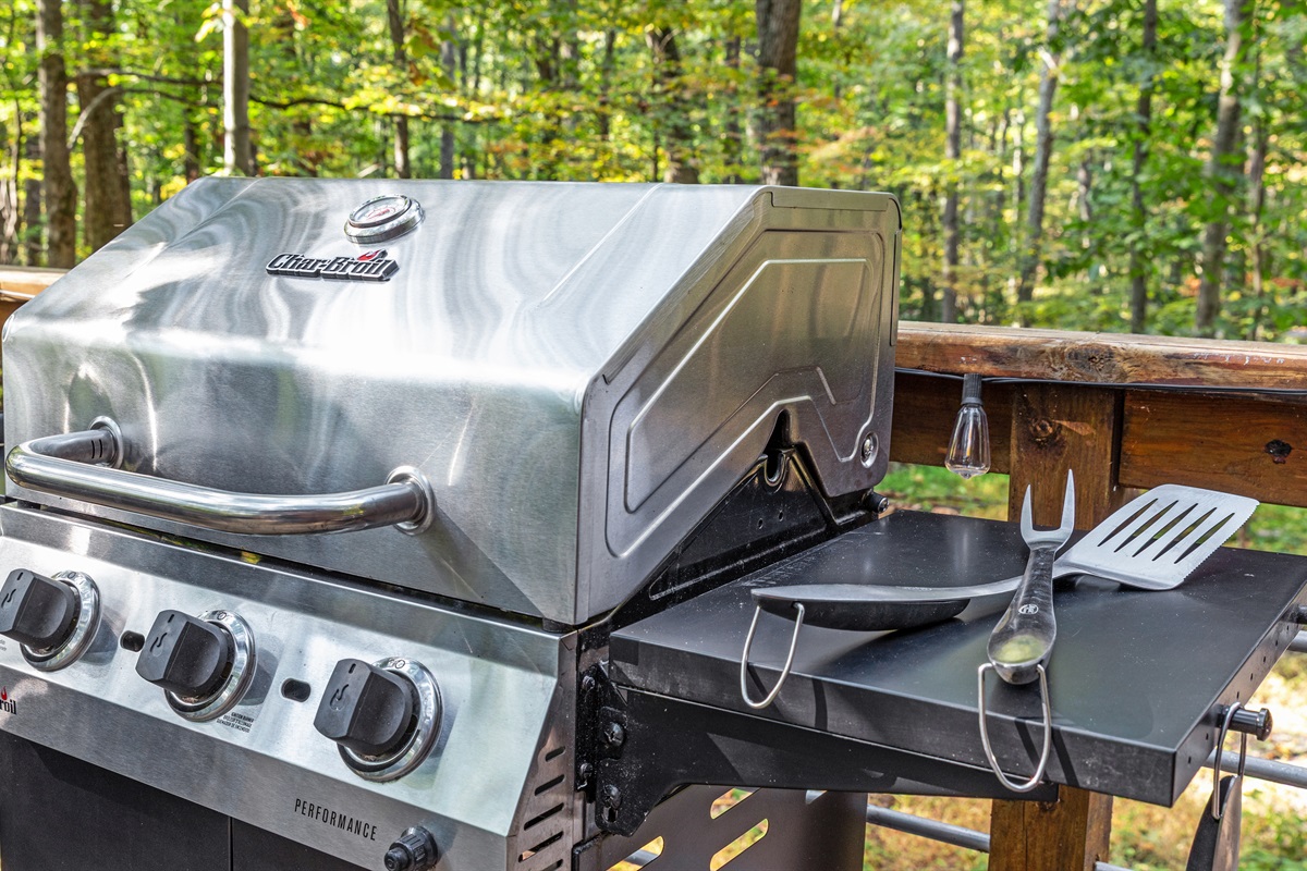 Fire up the grill! Fully stocked BBQ utensils and a beautiful view of the woods make for the perfect meal on the deck