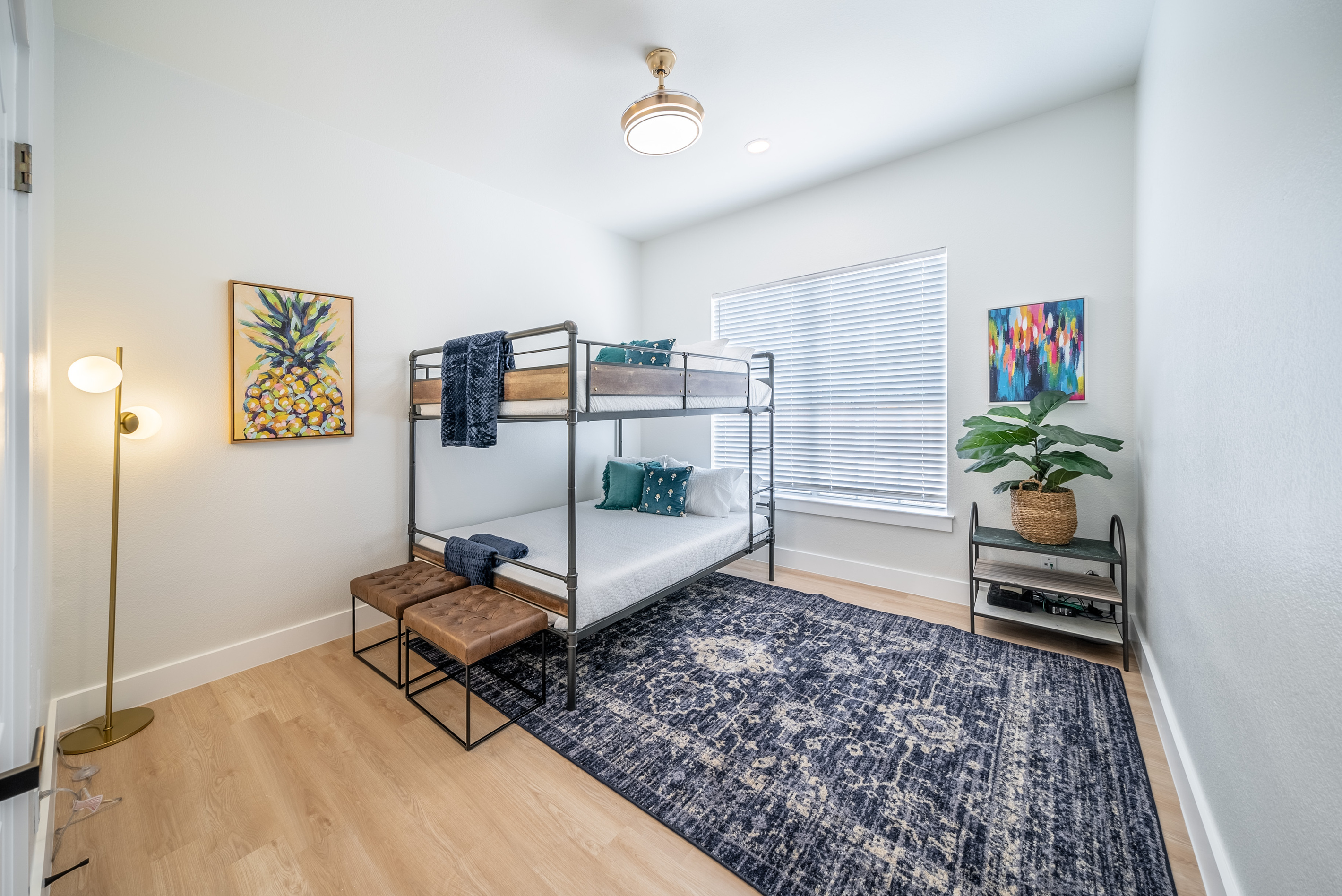 Cozy bunk room featuring a patterned rug and warm wood accents.