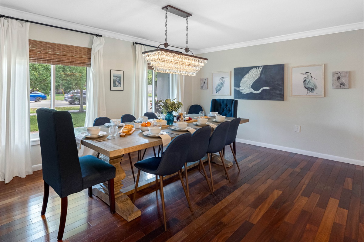 Charming details like the crystal chandelier and farmhouse barn doors make this dining space truly unique.
