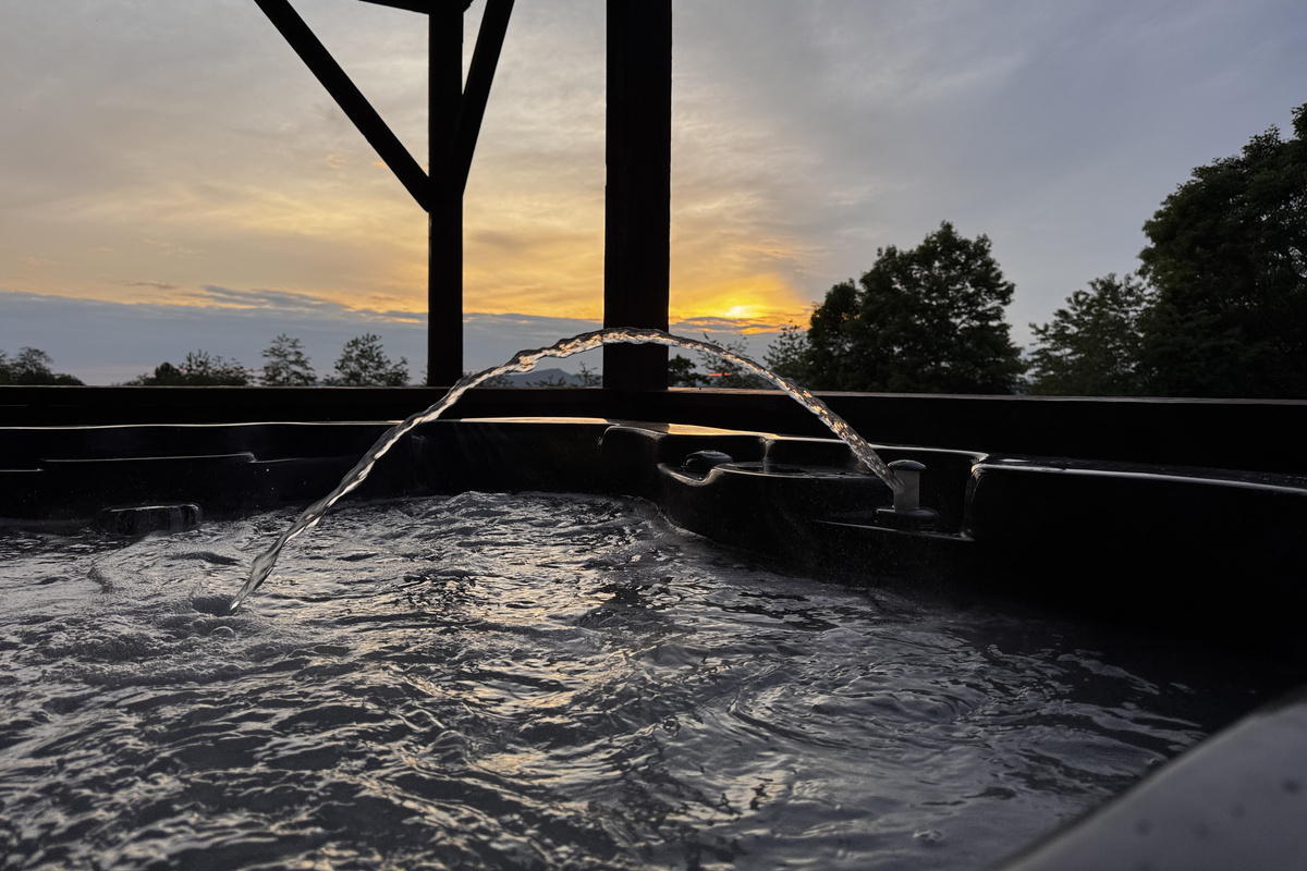 Private outdoor hot tub provides a relaxing retreat after hiking, mountain biking, skiing or exploring Western North Carolina.