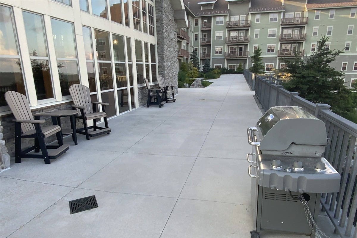 Large deck with gas grill and seating outside of "The Hearth Room
