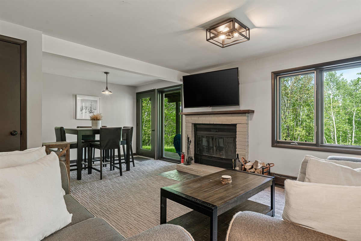 Unwind in the lower-level living room, equipped with a TV and cozy seating for movie nights or game days.