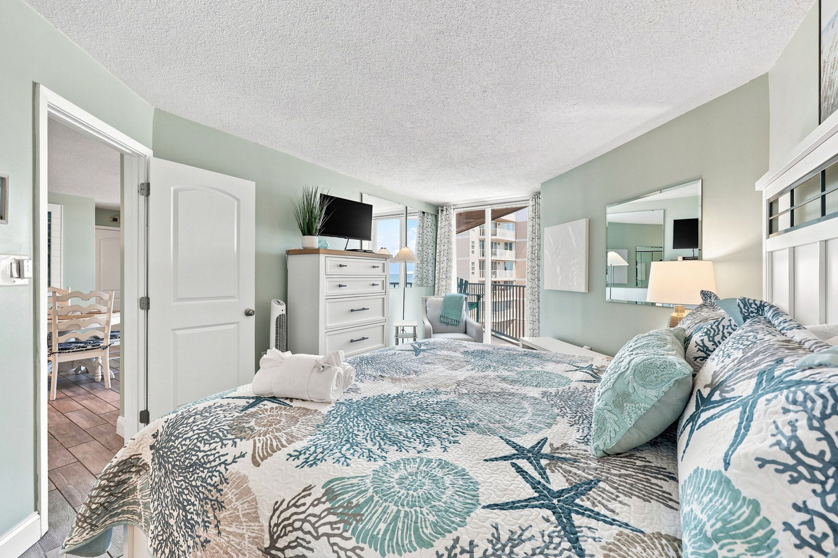 Bright and inviting bedroom showcasing a comfortable bed, soothing coastal colors, and plenty of space to unpack and settle in.
