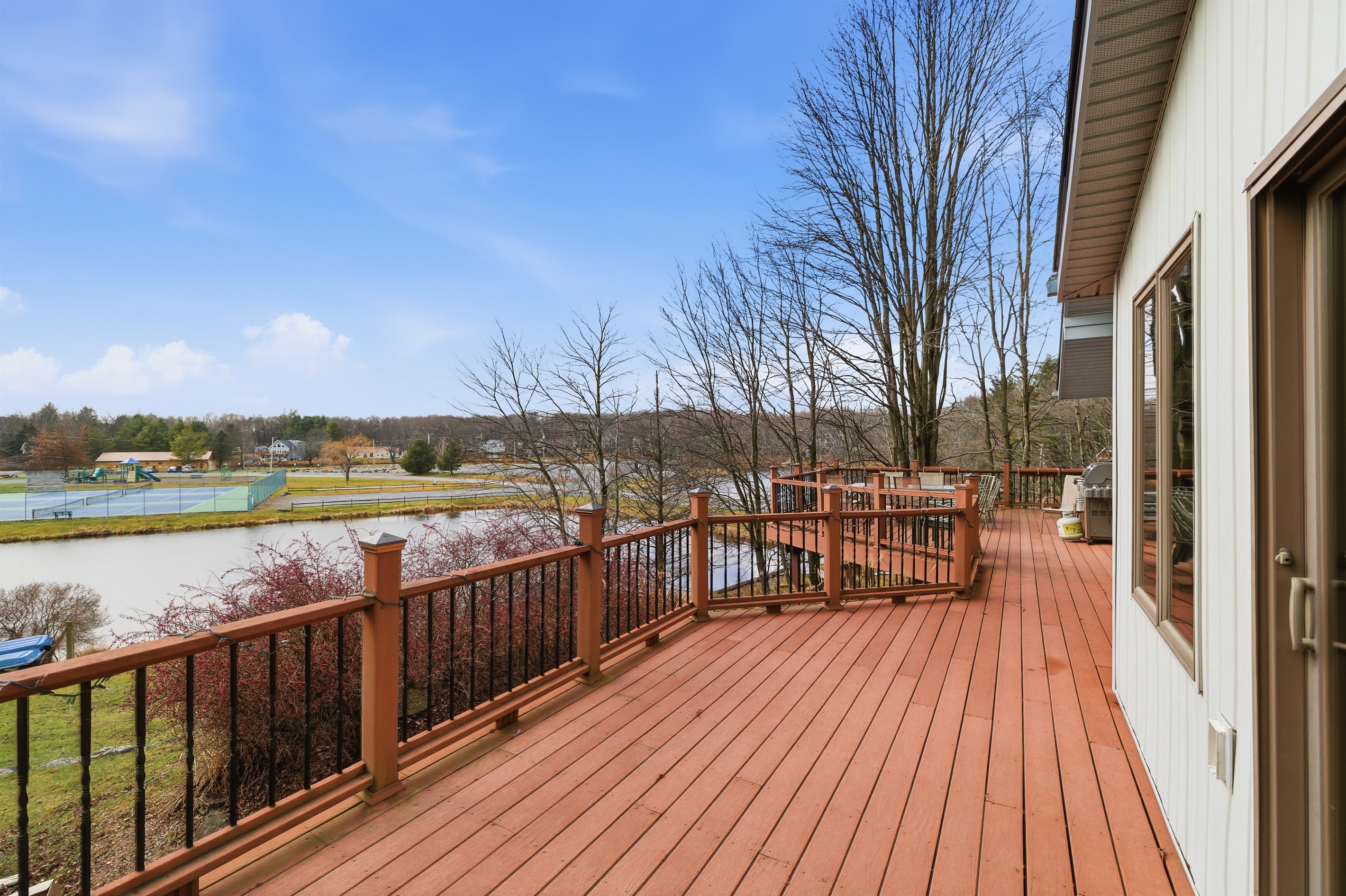 Deck overlooking the lake and Island complex.  Deck has BBQ grill and outdoor seating.