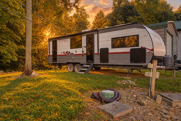 The camper sleeps 4 to 6 with a queen bedroom, sleeper sofa, dinette bed, full bathroom and kitchenette. A rare two-space Airbnb in the Smokies.