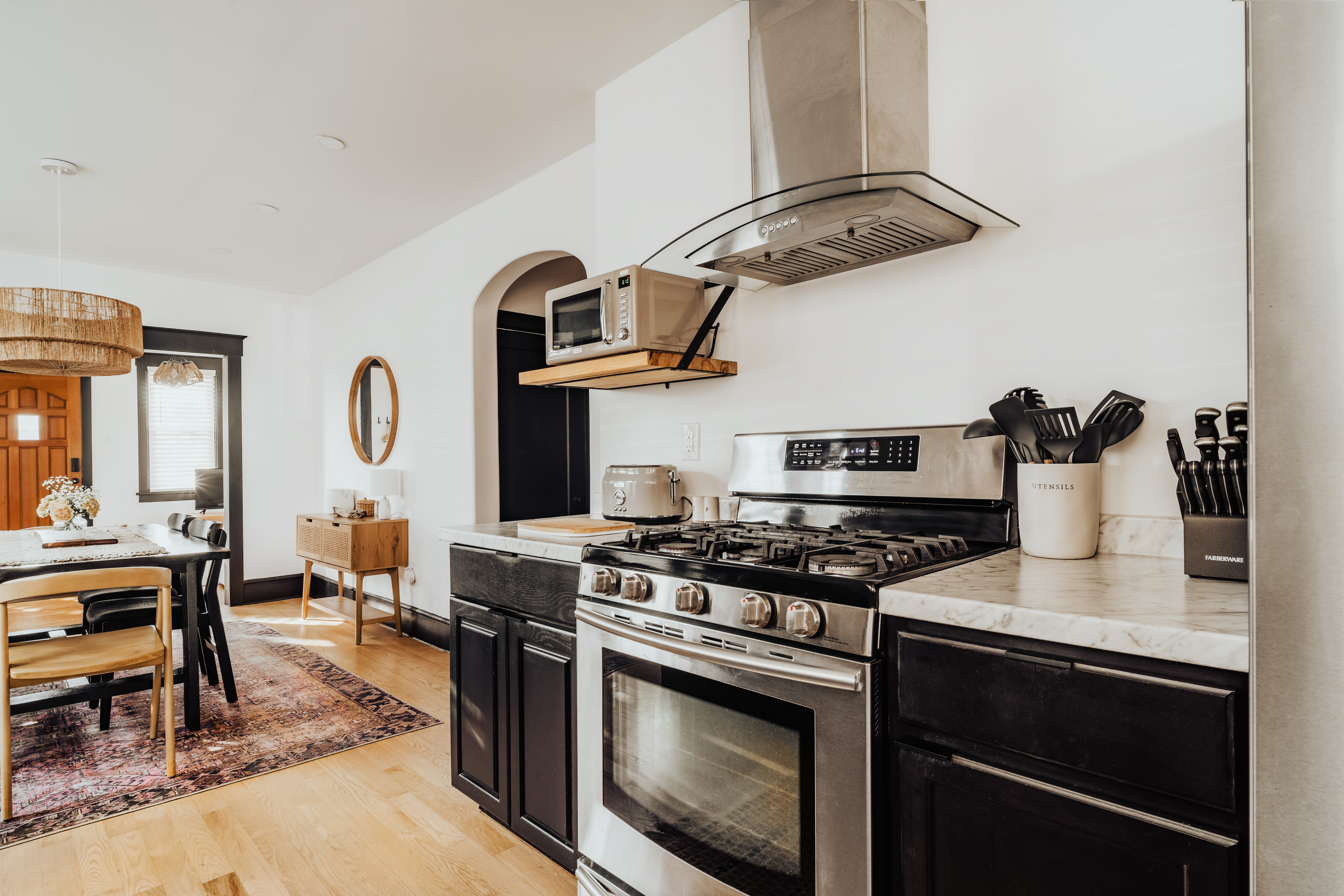 Close-Up View of Kitchen Gas Stove, Stainless Steel Hood, and Counter