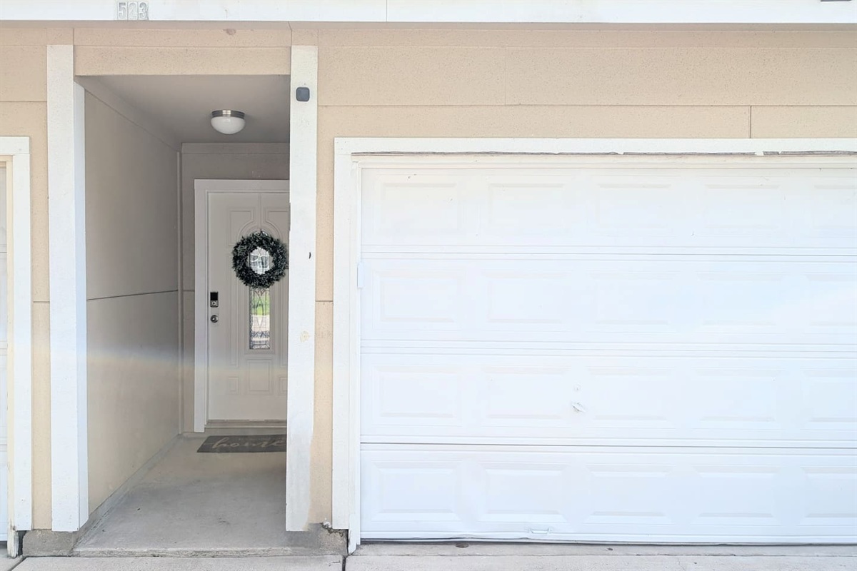Guests enter through a private entrance located to the left of the garage. 